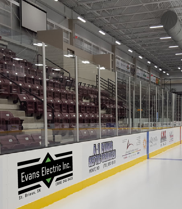 A mockup picture of what Evans Electric Inc logo would look like when placed on the local hockey rink boards